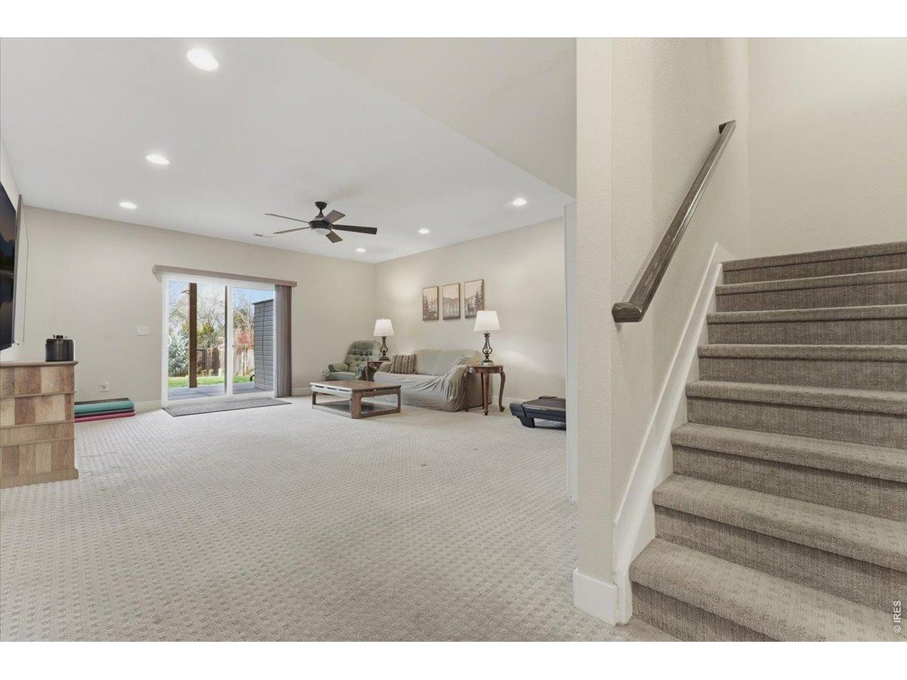 1148 Wagon Bend Road Berthoud, CO 80513 - Photo 33 of 50 basement stairs landing facing recreational room and walk-out slider