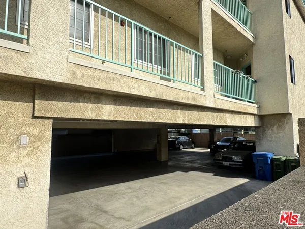 a view of a building with car parked