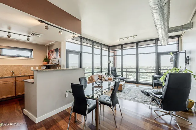 a dining room with furniture window and wooden floor