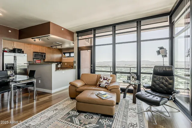 a living room with furniture and a floor to ceiling window