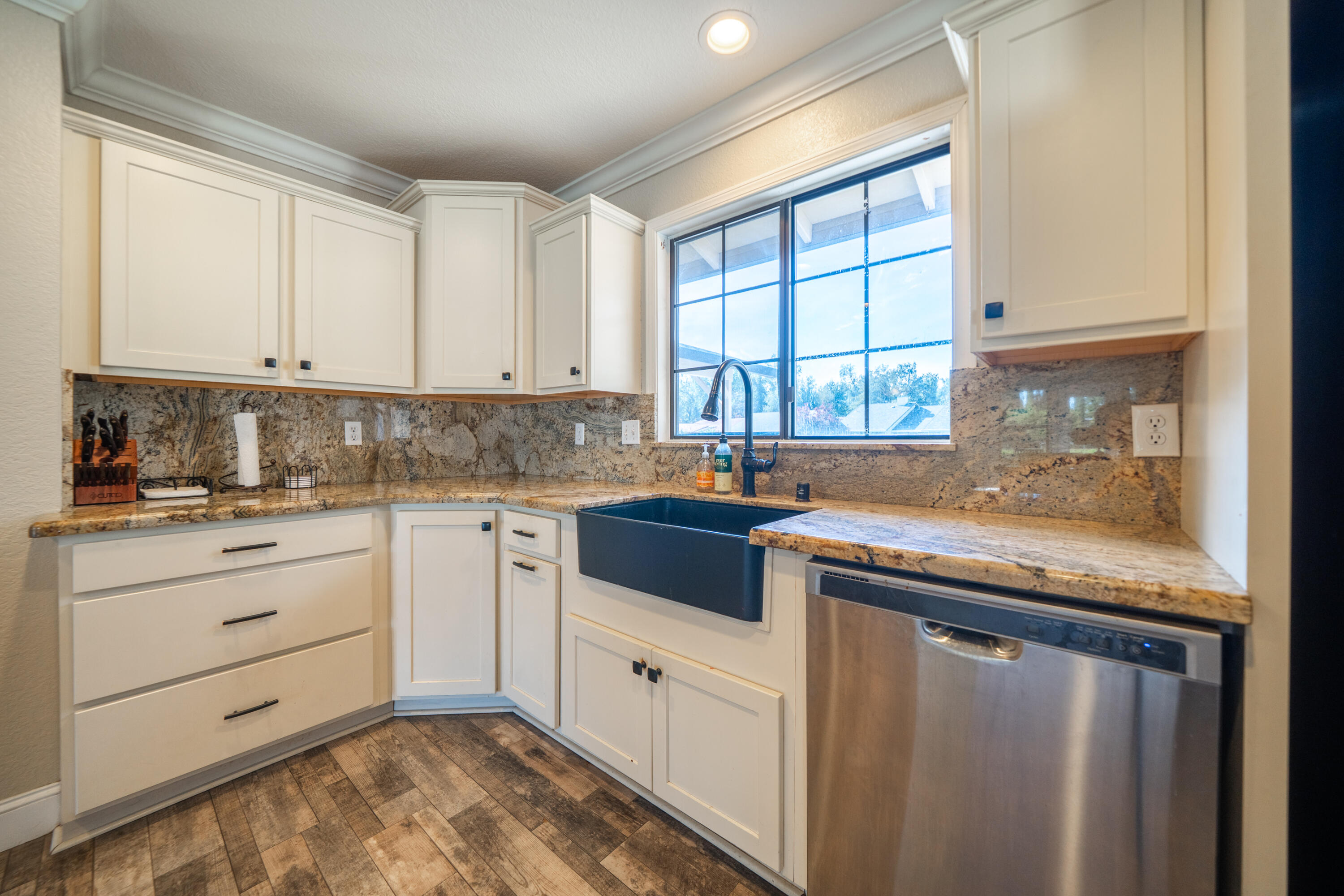7273 Amigo Way Redding, CA 96002 - Photo 12 of 59 a kitchen with granite countertop white cabinets and white appliances