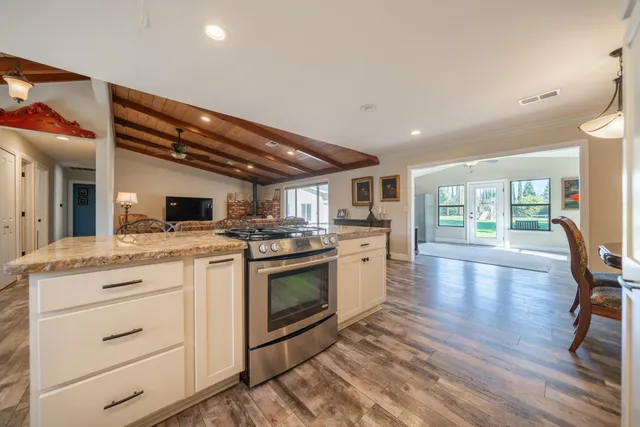 a kitchen with a stove a sink and a refrigerator