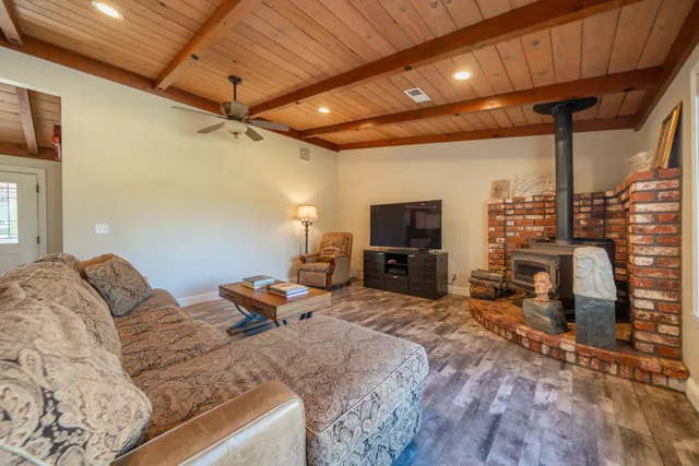 a bedroom with furniture and a flat screen tv
