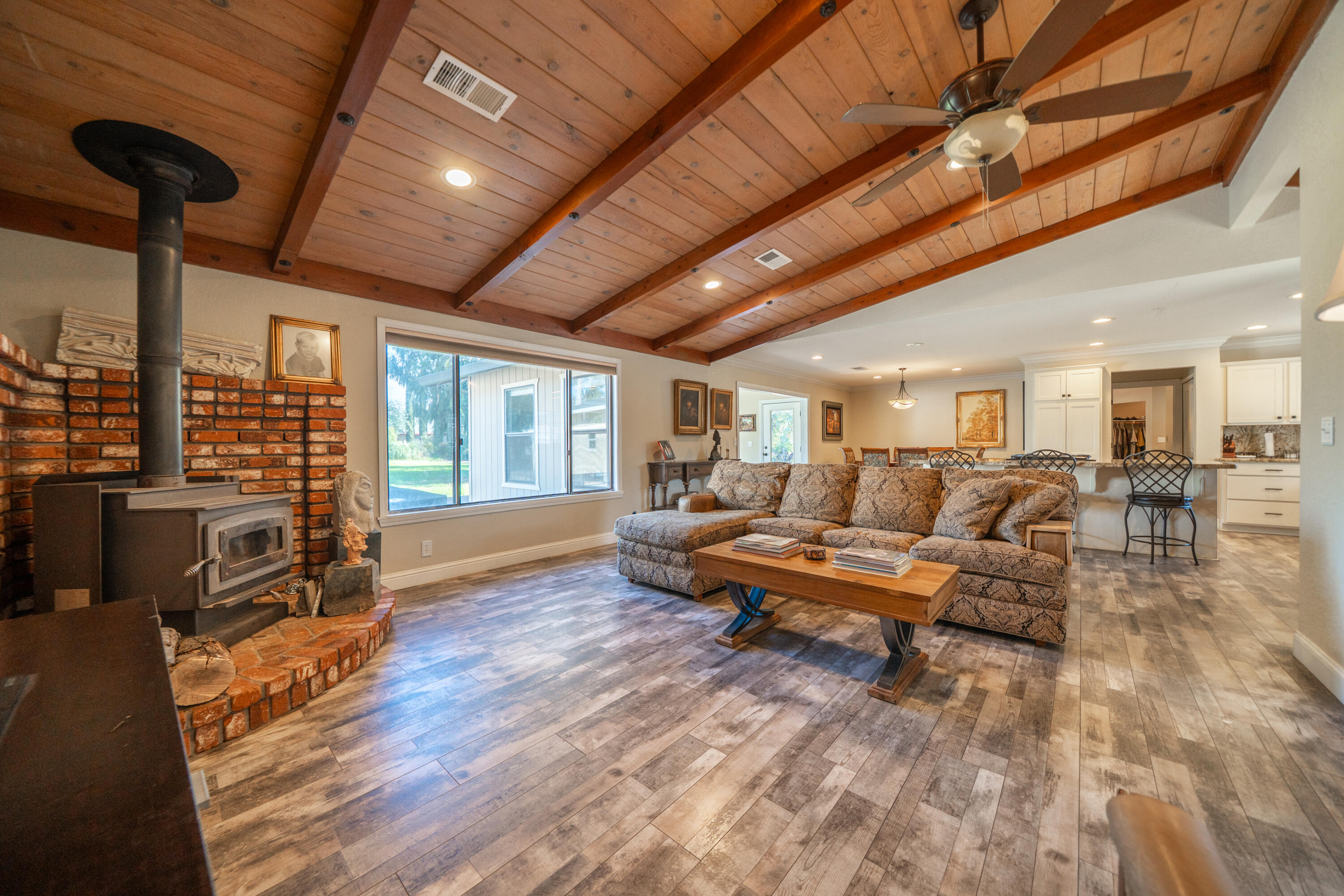 7273 Amigo Way Redding, CA 96002 - Photo 16 of 59 a living room with furniture a fireplace and wooden floor