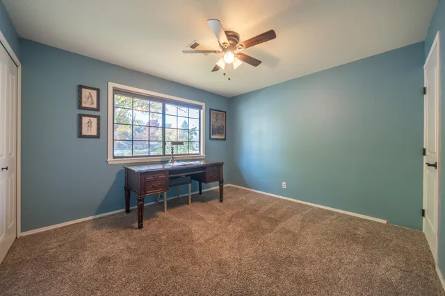 a view of a livingroom with a chandelier fan