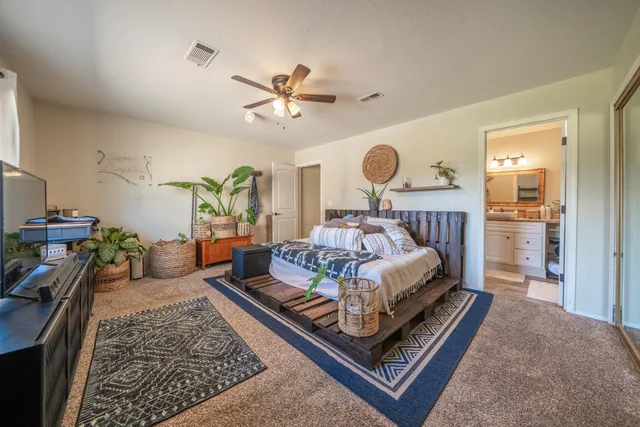 a spacious bathroom with a granite countertop sink a toilet and a mirror