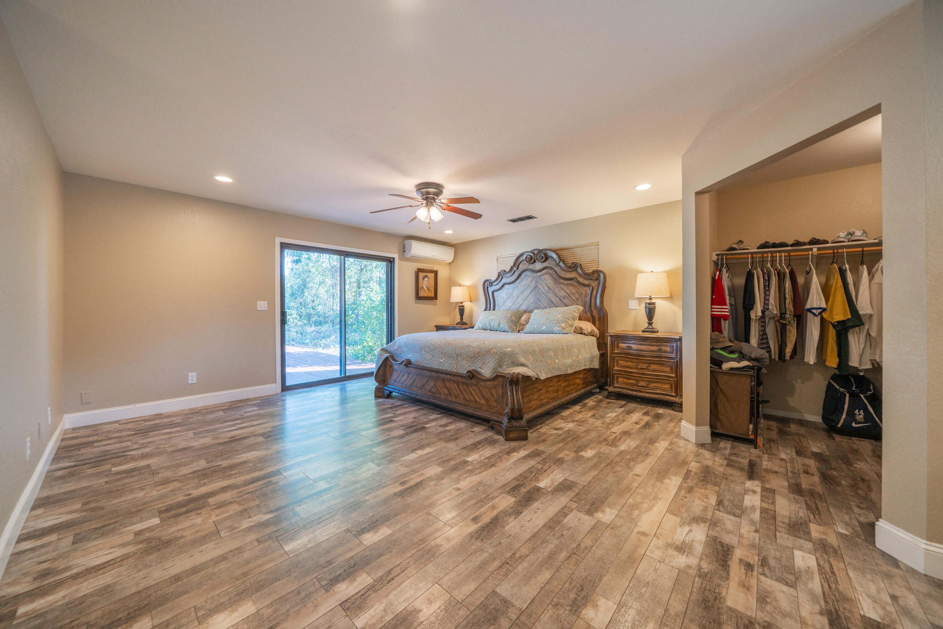 7273 Amigo Way Redding, CA 96002 - Photo 29 of 59 a spacious bedroom with a bed and a walk in closet