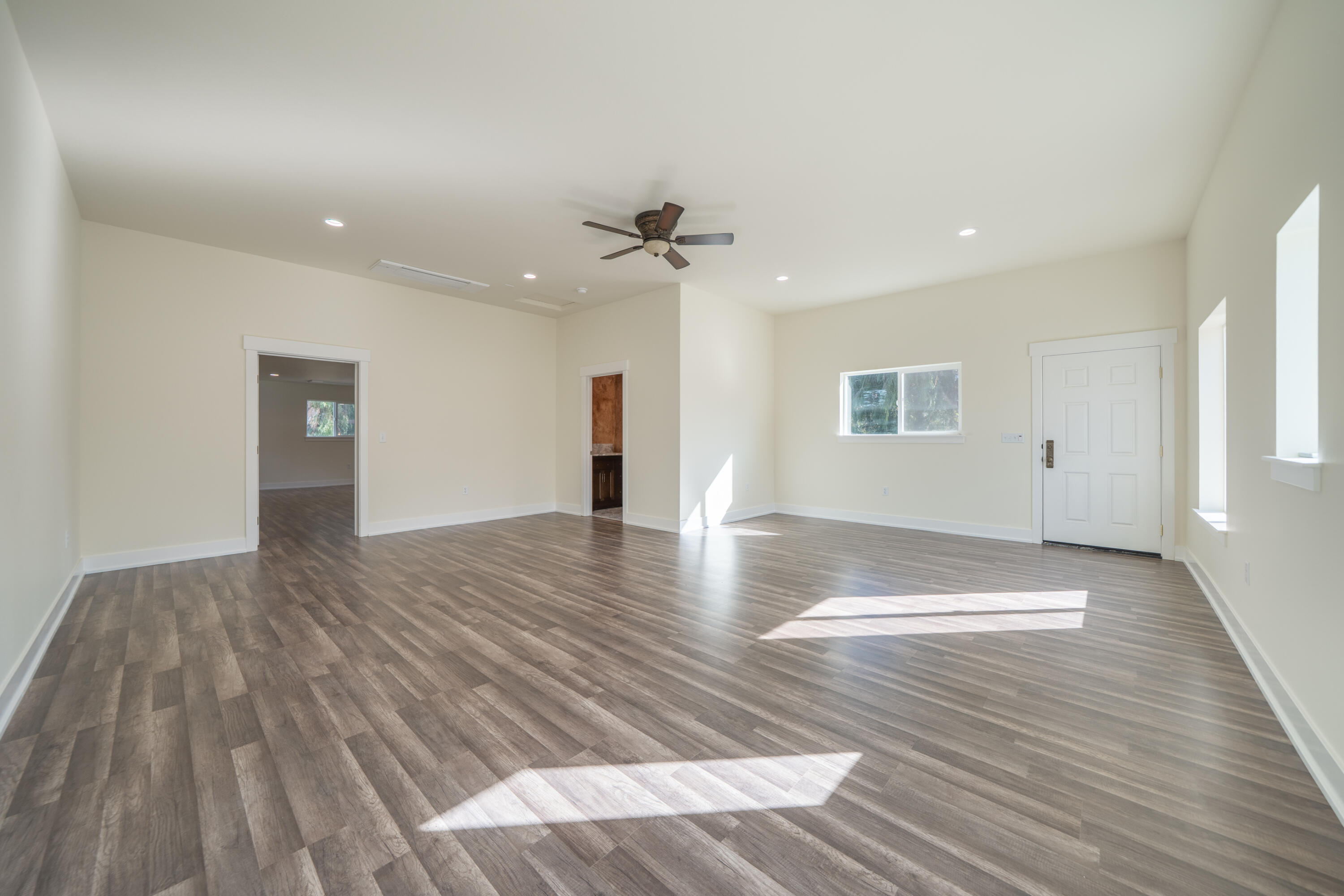7273 Amigo Way Redding, CA 96002 - Photo 38 of 59 a view of an empty room with wooden floor and a ceiling fan