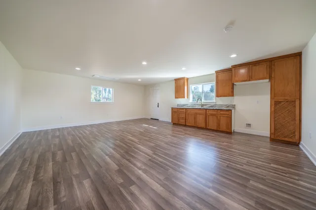a spacious bathroom with a granite countertop sink and a mirror