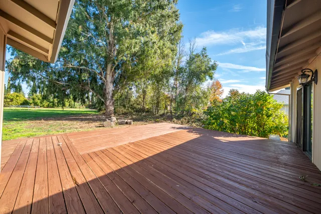 a view of outdoor space with deck and yard