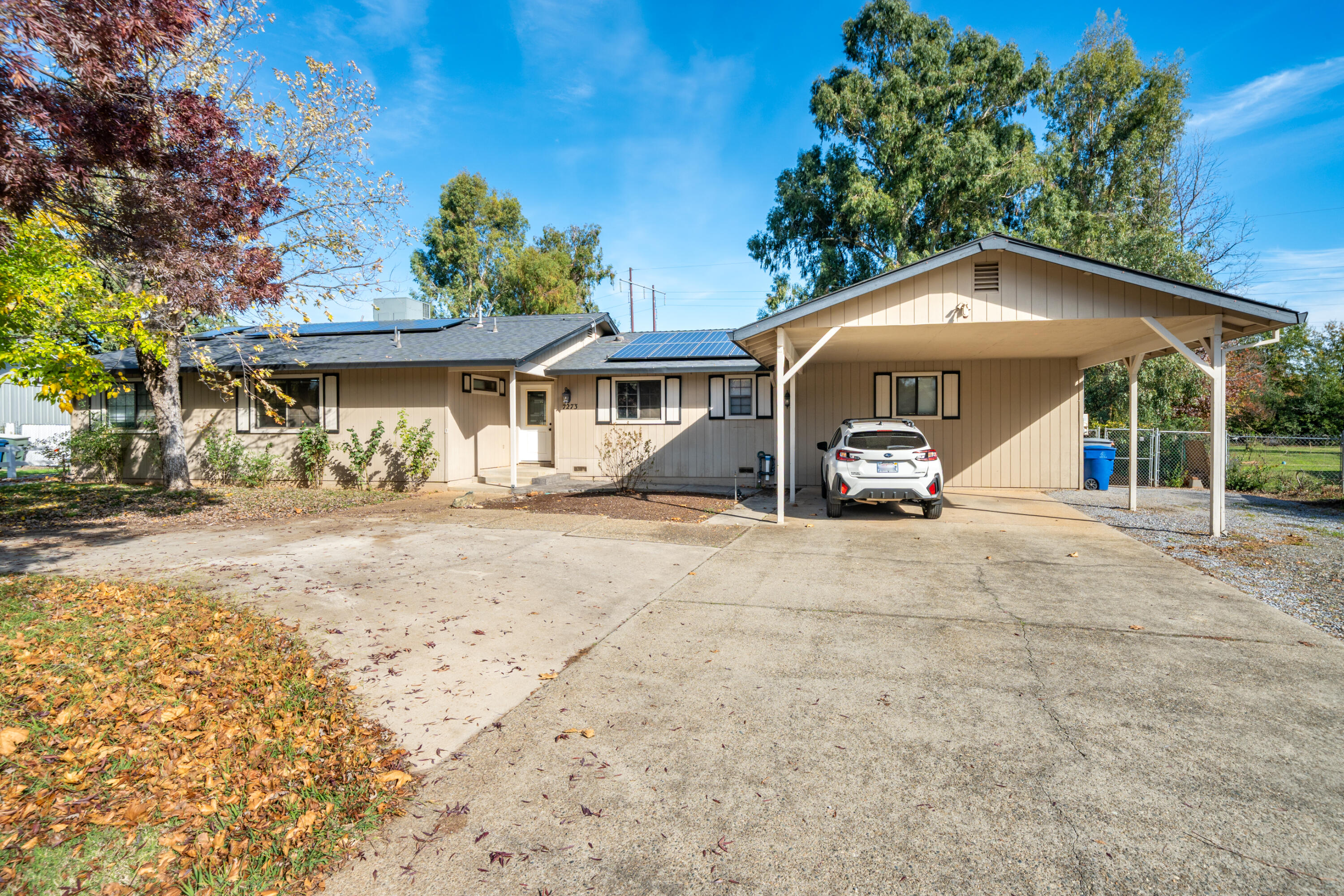 7273 Amigo Way Redding, CA 96002 - Photo 5 of 59 a front view of a house with a yard