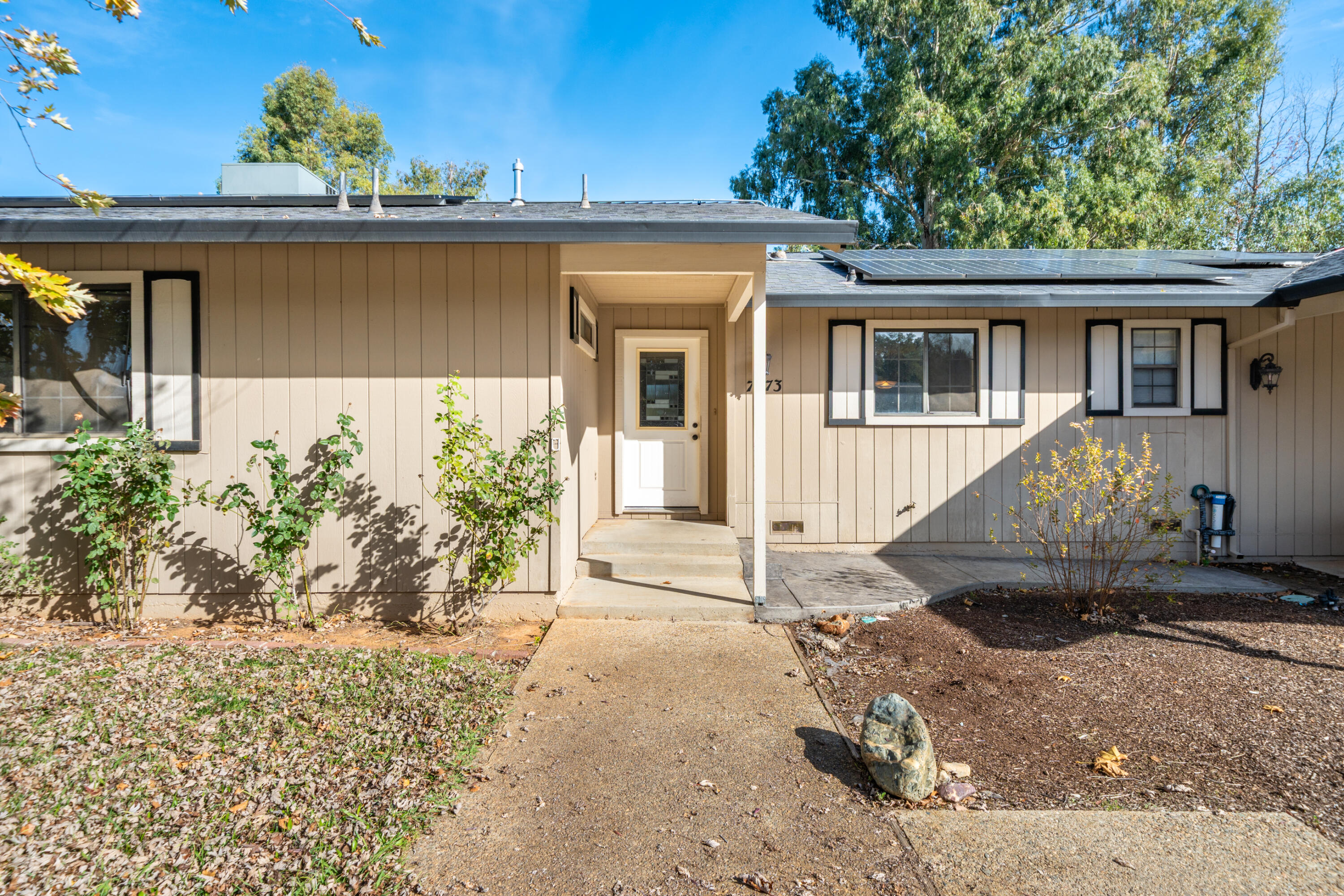 7273 Amigo Way Redding, CA 96002 - Photo 6 of 59 a front view of a house with garden