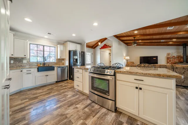 a kitchen with stainless steel appliances granite countertop a stove and a sink