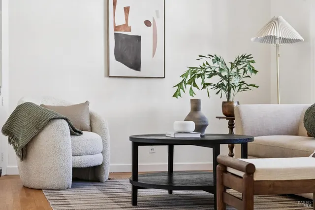 a living room with furniture a chandelier and a window