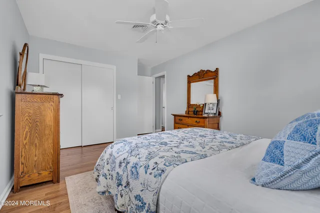 a bedroom with two beds and a painting on the wall