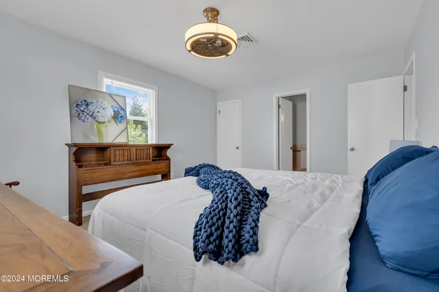 a bathroom with a sink a mirror a vanity and a shower