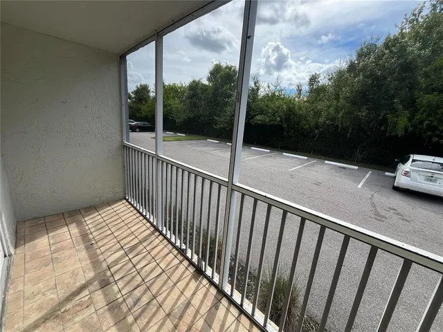 a view of a balcony with yard