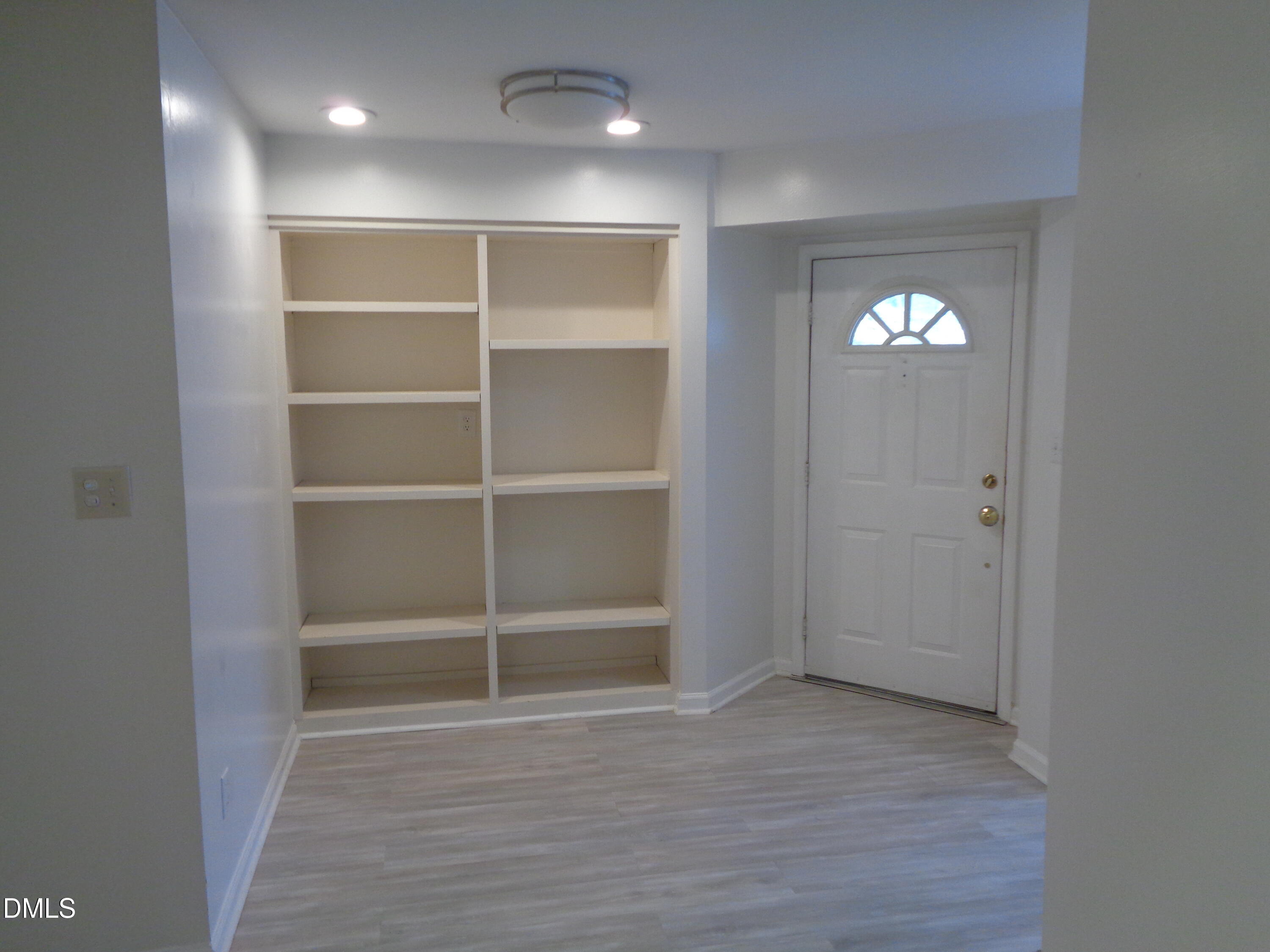 8331 Hempshire Place, Unit 102 Raleigh, NC 27613 - Photo 6 of 26 Bookcase in entry way