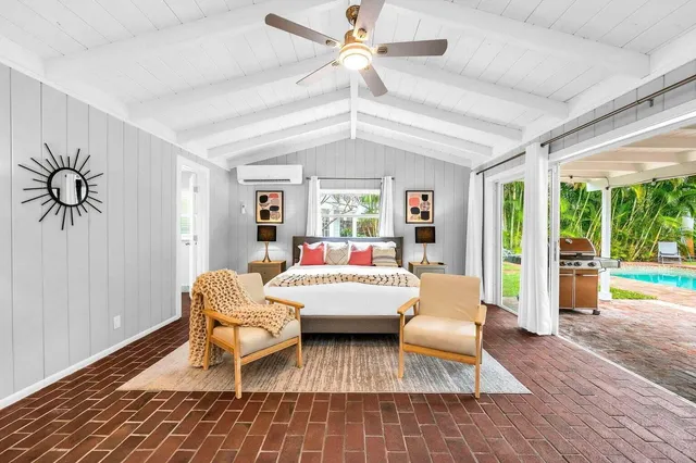 a living room with furniture and a large window with wooden floor