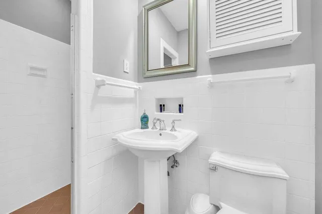 a bathroom with a sink a mirror and a toilet