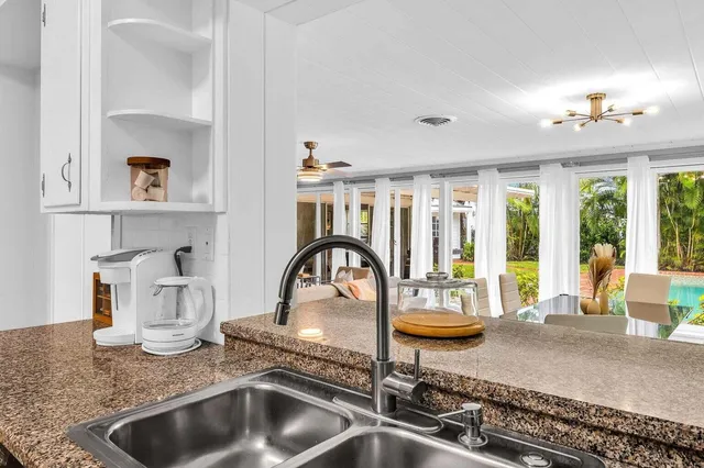 a kitchen with a faucet a sink and a window