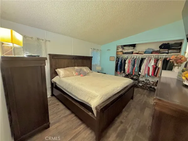 a bed sitting in a bedroom next to a window