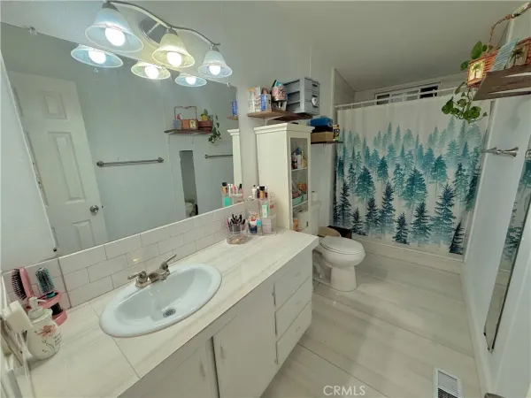 a bathroom with a sink toilet and shower