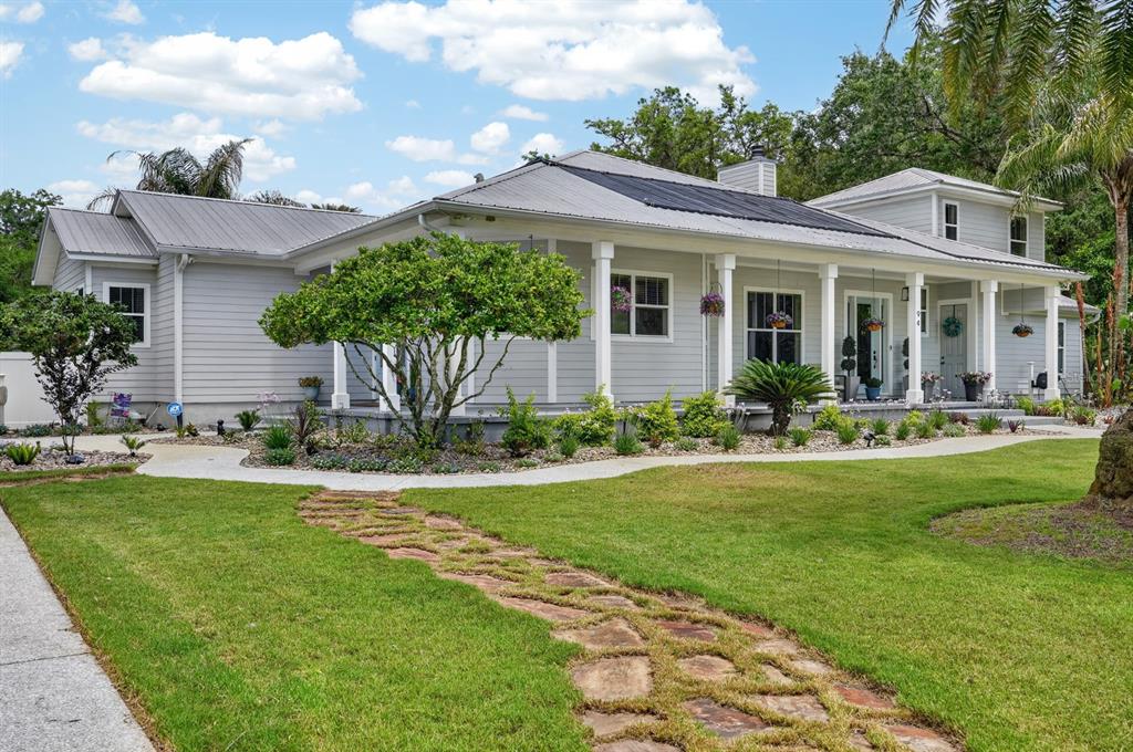 94 Smith Lane Bunnell, FL 32110 - Photo 4 of 80 a front view of a house with a garden and patio