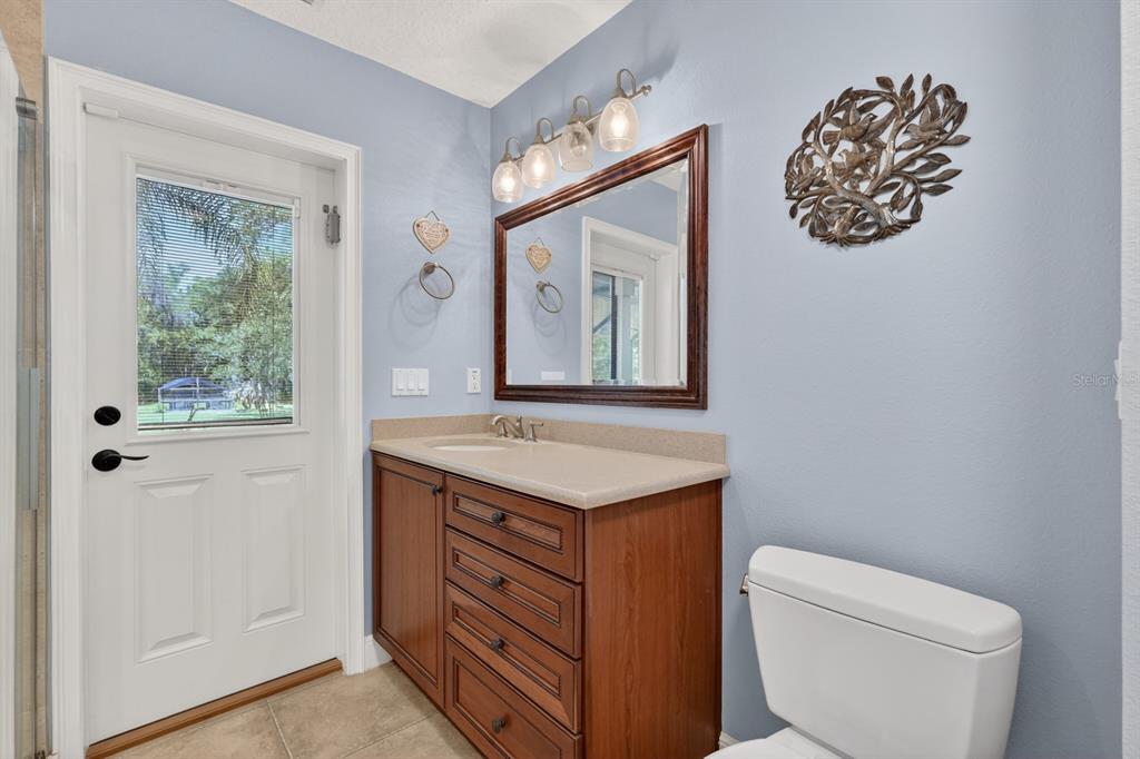 94 Smith Lane Bunnell, FL 32110 - Photo 45 of 80 a bathroom with a granite countertop toilet a sink and mirror