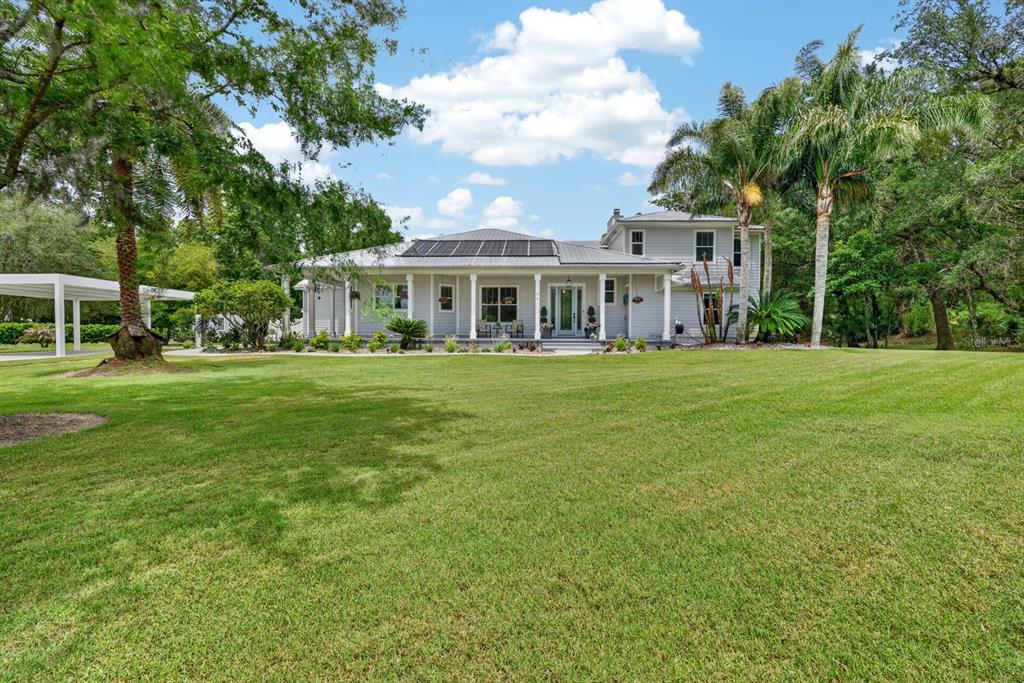 94 Smith Lane Bunnell, FL 32110 - Photo 5 of 80 a view of a house with a big yard and large trees