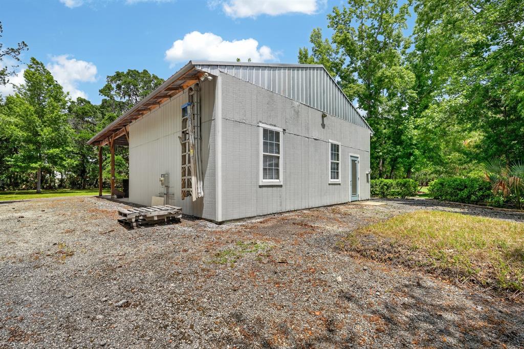94 Smith Lane Bunnell, FL 32110 - Photo 61 of 80 a view of a house with backyard and a tree