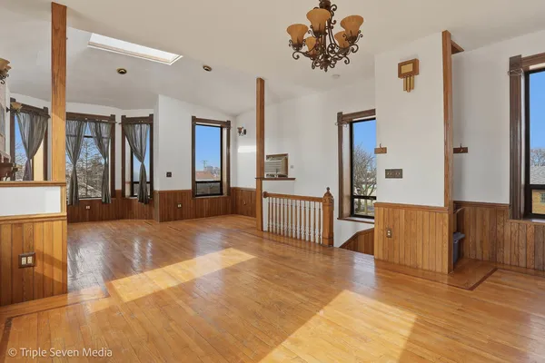 a kitchen with stainless steel appliances granite countertop a refrigerator a stove and a sink with wooden floor