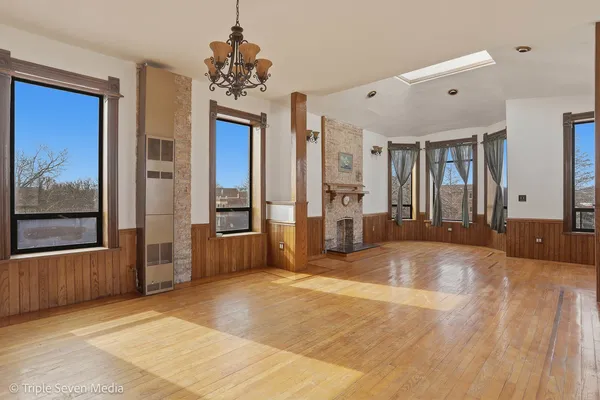 a kitchen with stainless steel appliances a sink cabinets and wooden floor