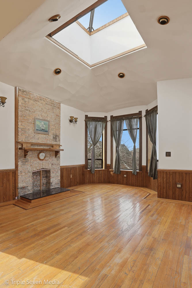 3315 South Wood Street Chicago, IL 60608 - Photo 32 of 80 a view of an empty room with wooden floor and a window