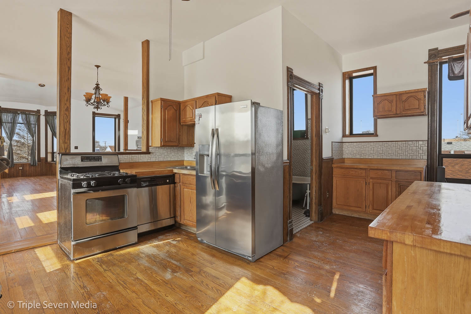 3315 South Wood Street Chicago, IL 60608 - Photo 47 of 80 a kitchen with stainless steel appliances granite countertop a refrigerator a stove and a sink with wooden floor