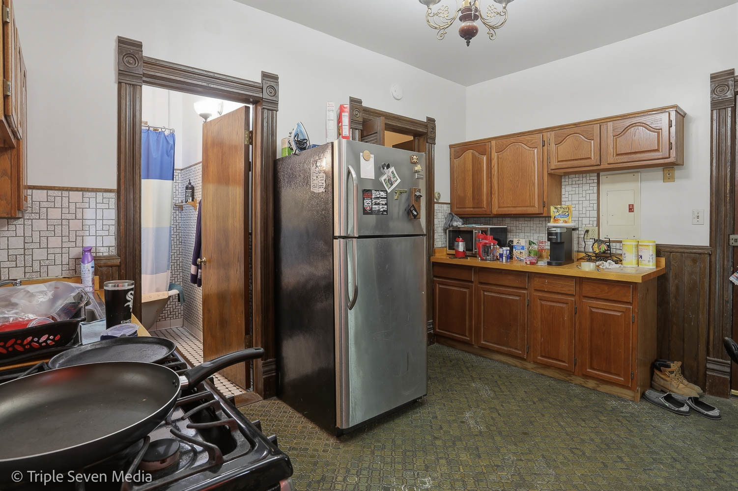 3315 South Wood Street Chicago, IL 60608 - Photo 69 of 80 a kitchen with stainless steel appliances granite countertop a refrigerator a stove and a sink with cabinets
