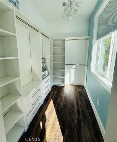 a view of walk in closet with empty racks