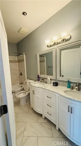 a bathroom with a double vanity sink and mirror