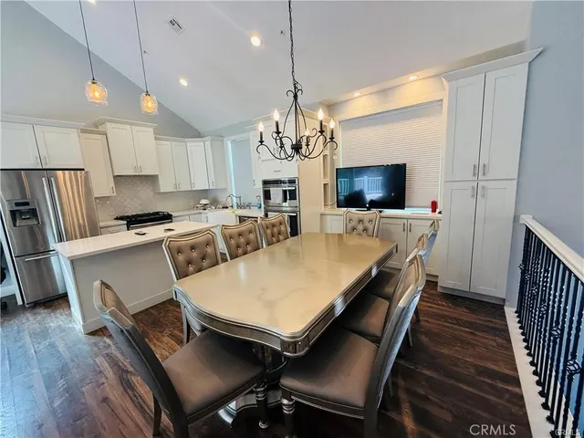 a large kitchen with a table and chairs