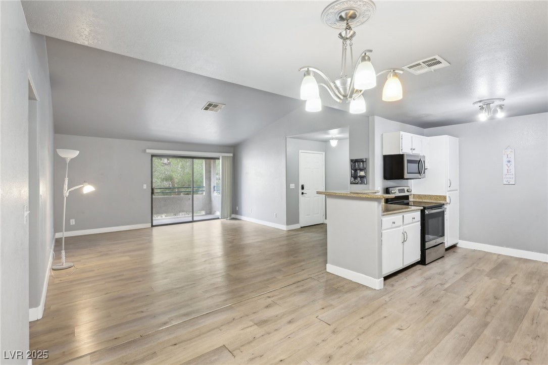 5241 South Lindell Road, Unit 202 Las Vegas, NV 89118 - Photo 11 of 35 Kitchen with white cabinets, an inviting chandelier, visible vents, and stainless steel appliances