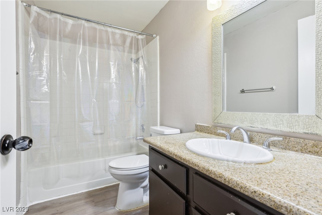 5241 South Lindell Road, Unit 202 Las Vegas, NV 89118 - Photo 32 of 35 Full bathroom with vanity, shower / tub combo, wood finished floors, and toilet