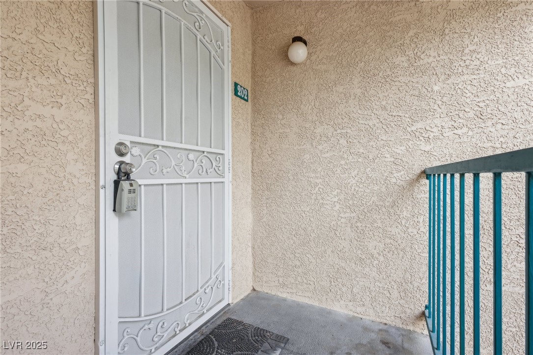 5241 South Lindell Road, Unit 202 Las Vegas, NV 89118 - Photo 4 of 35 View of exterior entry featuring stucco siding