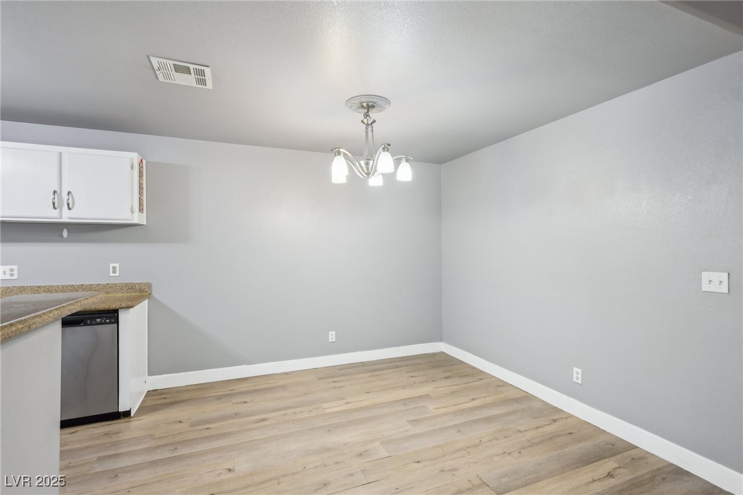 5241 South Lindell Road, Unit 202 Las Vegas, NV 89118 - Photo 9 of 35 Kitchen with baseboards, visible vents, white cabinets, dishwasher, and light wood-style flooring
