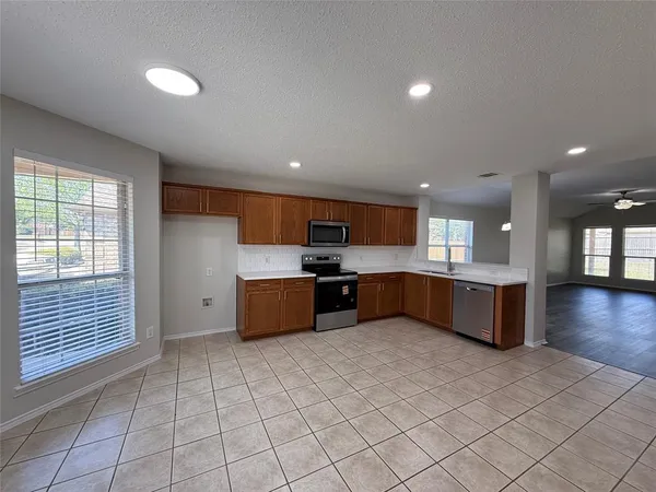 a large kitchen with stainless steel appliances lots of counter top space