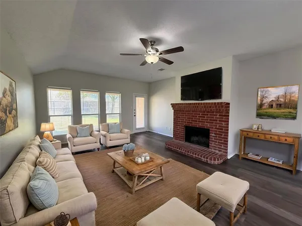 wooden floor fireplace and windows in an empty room