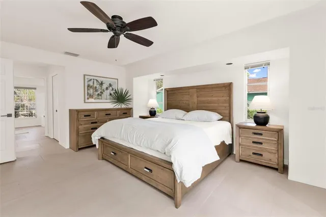 a bedroom with a large bed and a chandelier