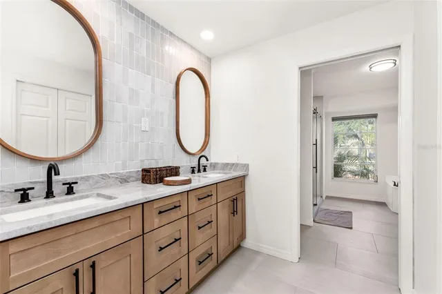 a bathroom with 2 sink and a mirror