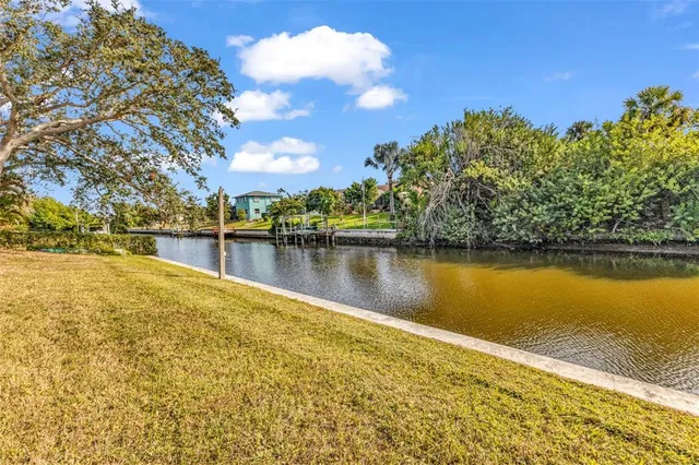 a view of a lake with houses in the background