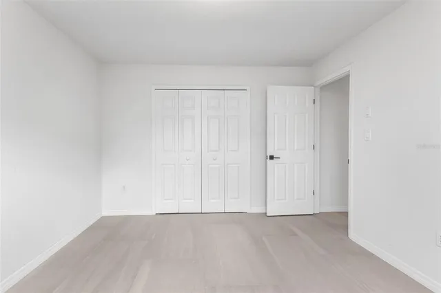 a en suite bathroom with a granite countertop tub a double vanity sink and a mirror