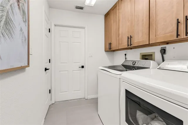 a view of a livingroom with a fireplace and large windows
